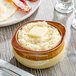 A bowl of Jim Dandy regular grits with a pat of butter on top.