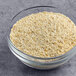 A bowl of Jim Dandy regular grits on a gray surface.