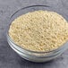 A bowl of Jim Dandy regular grits on a gray surface.
