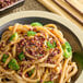 A bowl of noodles with broccoli and HUNSTY Red Sichuan Peppercorn sprinkles.