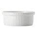 A white porcelain souffle dish with a ribbed edge.