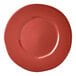 A close-up of a Libbey Farmhouse red porcelain plate with a wide rim.