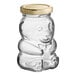 A clear glass bear jar with a gold metal lid.