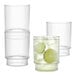 Three Tossware Reserve fluted tumbler glasses with lime wedges in them.