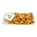 Breaded dill pickle cheese curds with white sauce on a plate.