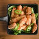 Breaded jalapeno cheese curds in a pan of fried food.