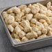 A metal tray filled with breaded jalapeno cheese curds.
