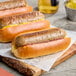 Impossible Foods Plant-Based Vegan Bratwurst Sausages on a wooden board.