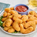 A plate of Mind Blown plant-based crispy fried shrimp with red sauce.