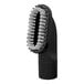 A close-up of a black and white Sanitaire brush.
