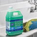 A gloved hand pouring Spic and Span all purpose cleaner from a green gallon container.