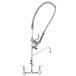 A T&amp;S chrome pre-rinse faucet with a hose attached to it.