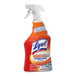 A bottle of Lysol Kitchen Pro antibacterial cleaner spray on a professional kitchen counter.
