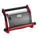 A red and black plastic Tork wall-mount wiper roll dispenser.