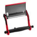 A red and black Tork wall-mount wiper roll dispenser.