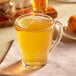 A glass of Bigelow Lemon and Echinacea tea with a lemon slice on top.
