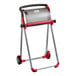 A red and silver rolling cart with a Tork logo.
