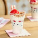 A clear 15 oz. plastic parfait cup filled with yogurt, granola, berries, and wafer sticks.