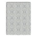 A close up of a blue and white patterned blanket with circles on a white surface.