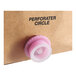 A pink circle on a plastic object.