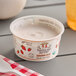 A white container of Painterland Sisters Strawberry Fields organic skyr yogurt on a table.