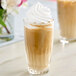 A glass of coffee with whipped cream on top using SHOTT Cane Sugar syrup.
