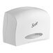 A white Scott® toilet tissue dispenser with a clear cover over the stub roll section.