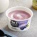 A container of So Delicious Blueberry Coconut Yogurt with a blue and white label.