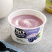A container of So Delicious Blueberry Coconut Yogurt with blueberries on top.