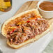 A sandwich with Vienna Beef Italian-Style Sliced Roast Beef and gravy on a white plate.