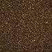A close-up of a pile of small brown crushed barley pieces.