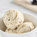 A close-up of a scoop of Bravo Gelato peanut butter chocolate chip gelato with chocolate chips.