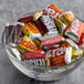 A bowl of HERSHEY's Assorted Individually Wrapped Miniature Candy on a hotel buffet counter.
