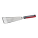 A stainless steel slotted fish and egg turner with a red and black nylon handle.