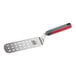 A stainless steel perforated turner with a rounded edge and a red and gray nylon handle.