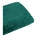 A white bath towel with a dark green border.