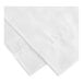 A close-up of a white 1888 Mills Beyond Woven chain link top sheet with a folded edge.