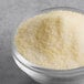 A bowl of True Citrus crystallized lemon powder on a table.