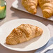 A close-up of a Le Chic Patissier Vegan Spelt Flour and Quinoa Croissant on a plate.