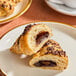 Two Le Chic Patissier chocolate croissants on a plate.