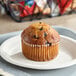 An Otis Spunkmeyer Wild Blueberry muffin on a plate.