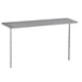 A silver stainless steel table mounted shelf above a long silver table.