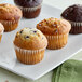 A white plate of Otis Spunkmeyer muffins.