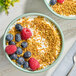 A bowl of yogurt topped with berries.