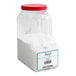 A white plastic container of white powder with a red lid.