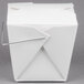 A white Chinese take-out box with a wire handle.