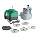 A commercial food processor with a green and black base, gray feed attachment, power cord, and six interchangeable metal discs.
