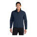 A man wearing a Port Authority dress blue core soft shell jacket.