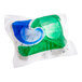 A close-up of a green and blue gel capsule with a white background.