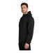 A person wearing a black Port Authority Essential Rain Jacket.